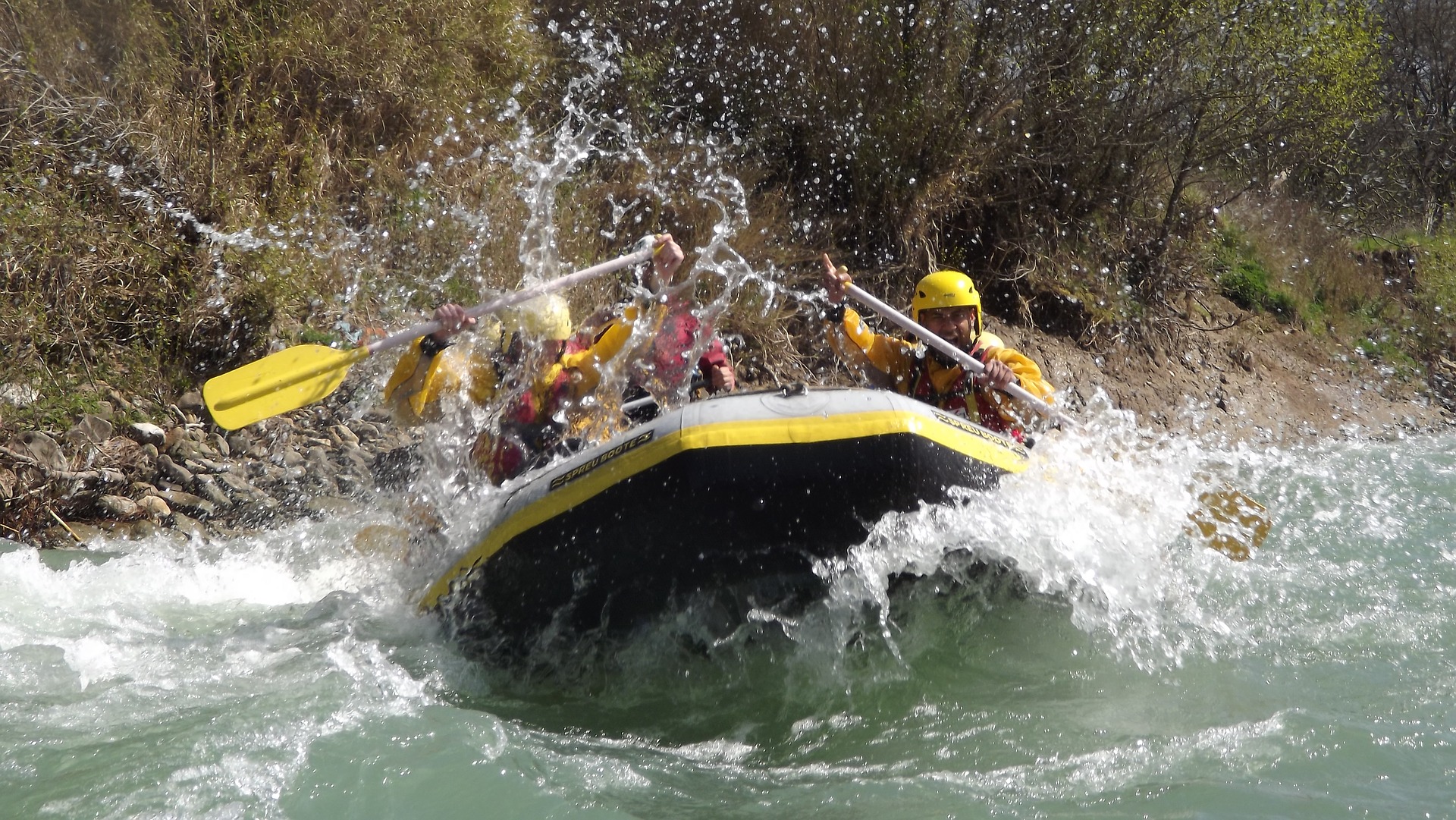 People white water rafting in an inflatable boat